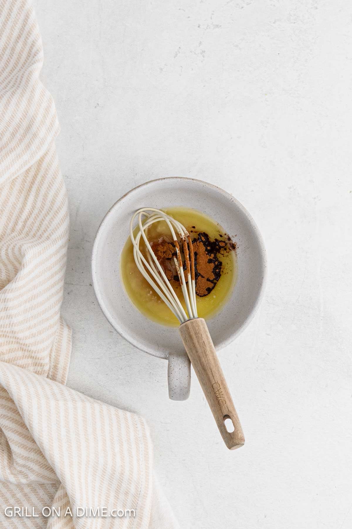 Combining the glaze ingredients in a bowl with a whisk.
