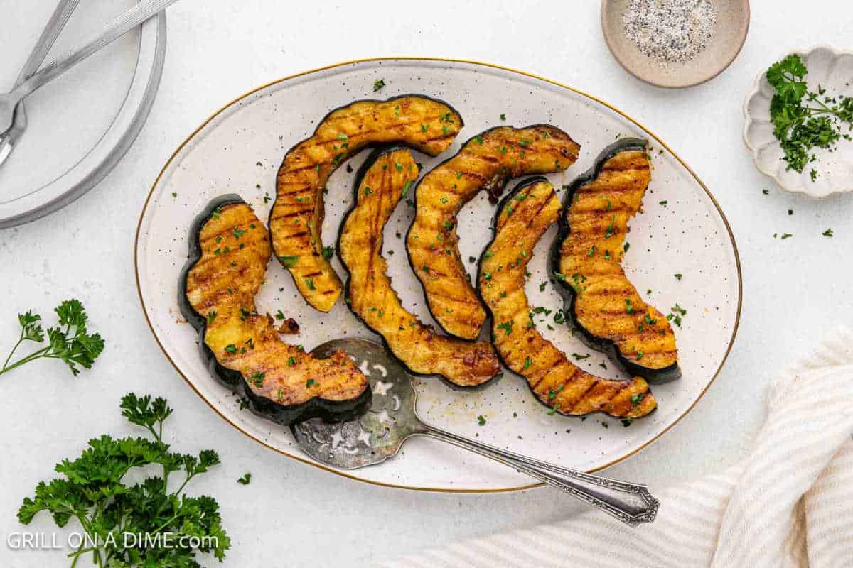 Grilled Acorn Squash slices on a platter.