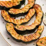 Slices of Grilled Acorn Squash on a platter.