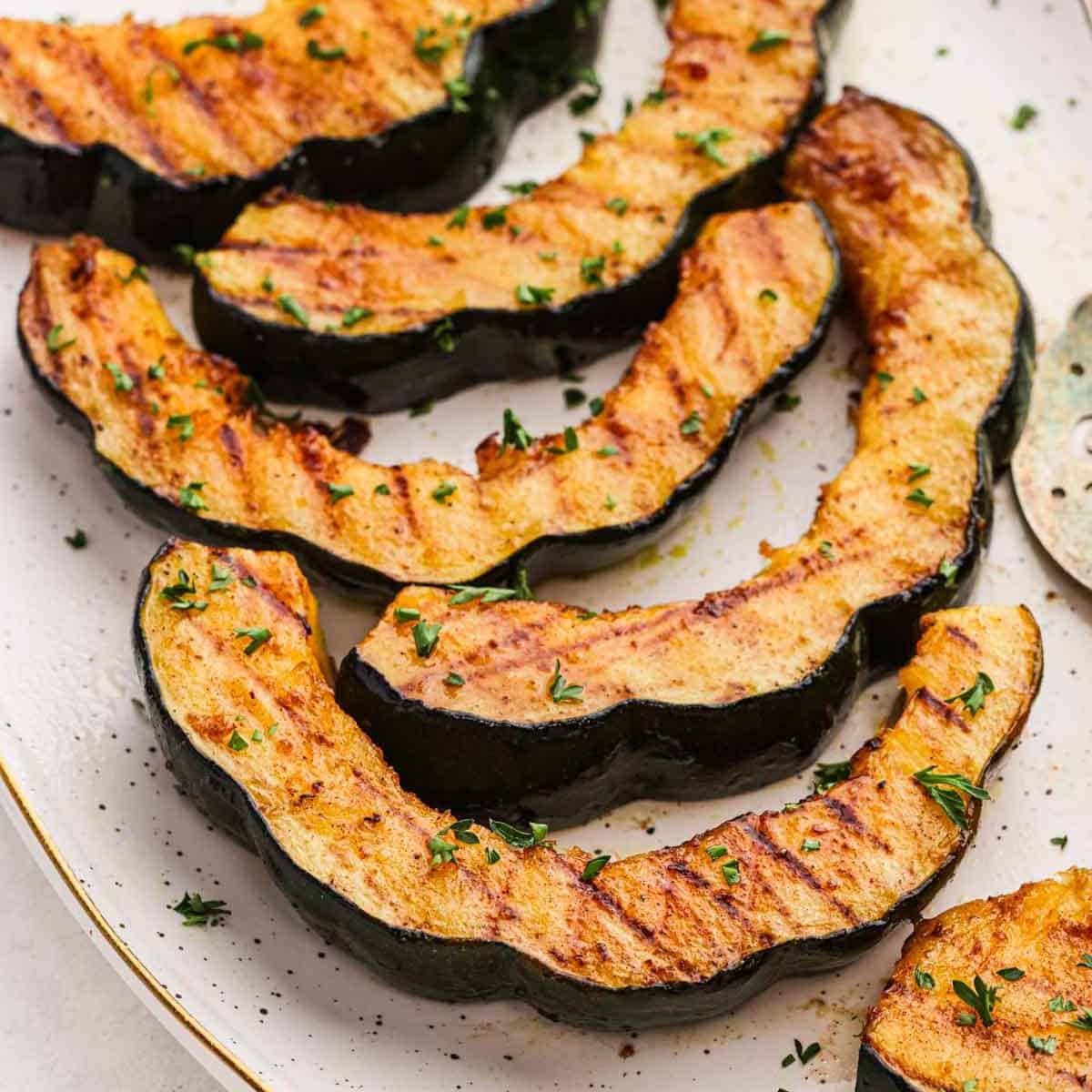 Slices of Grilled Acorn Squash on a platter.