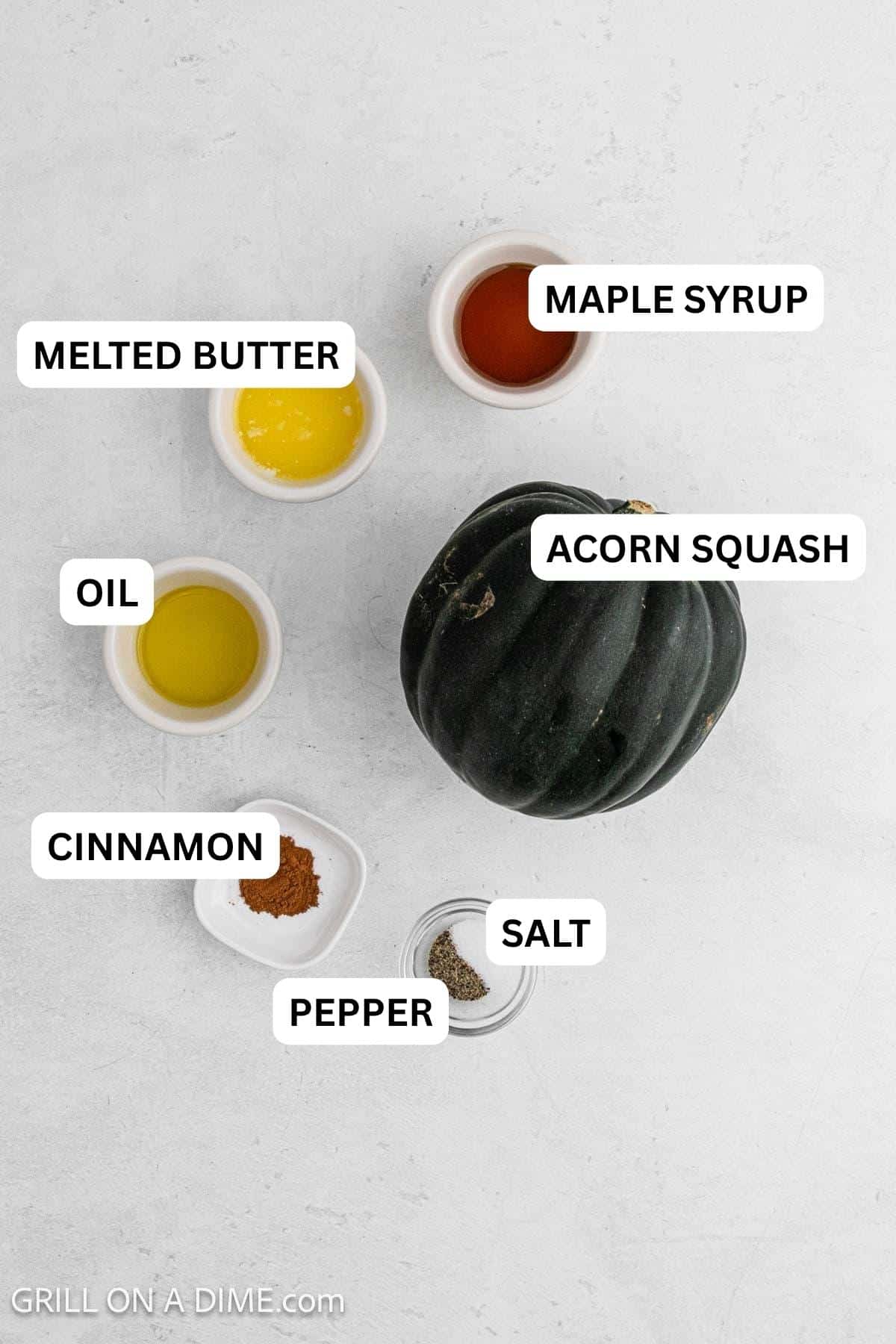 Ingredients needed for this recipe includes acorn squash, olive oil, maple syrup, butter, cinnamon and salt and pepper.