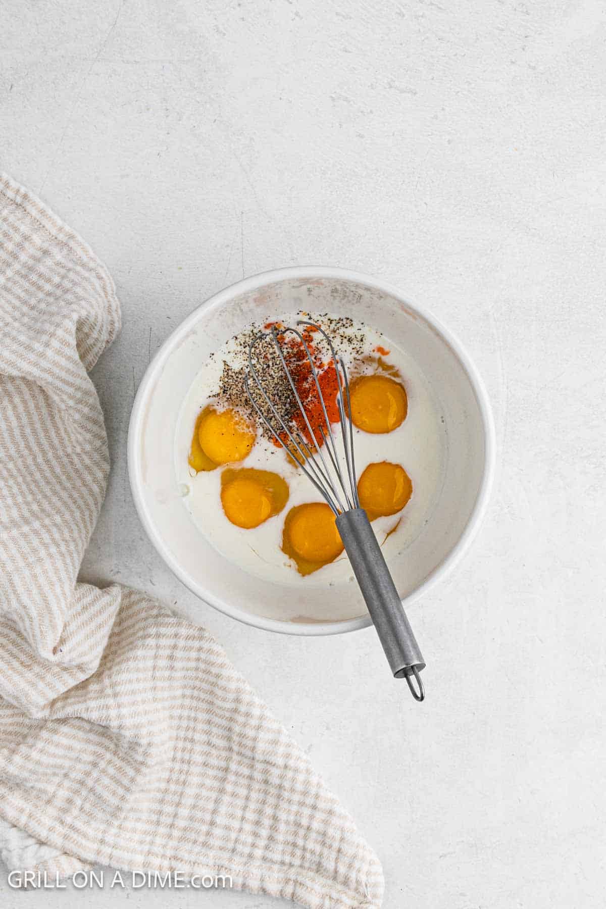 Eggs and spices in a bowl with milk. 